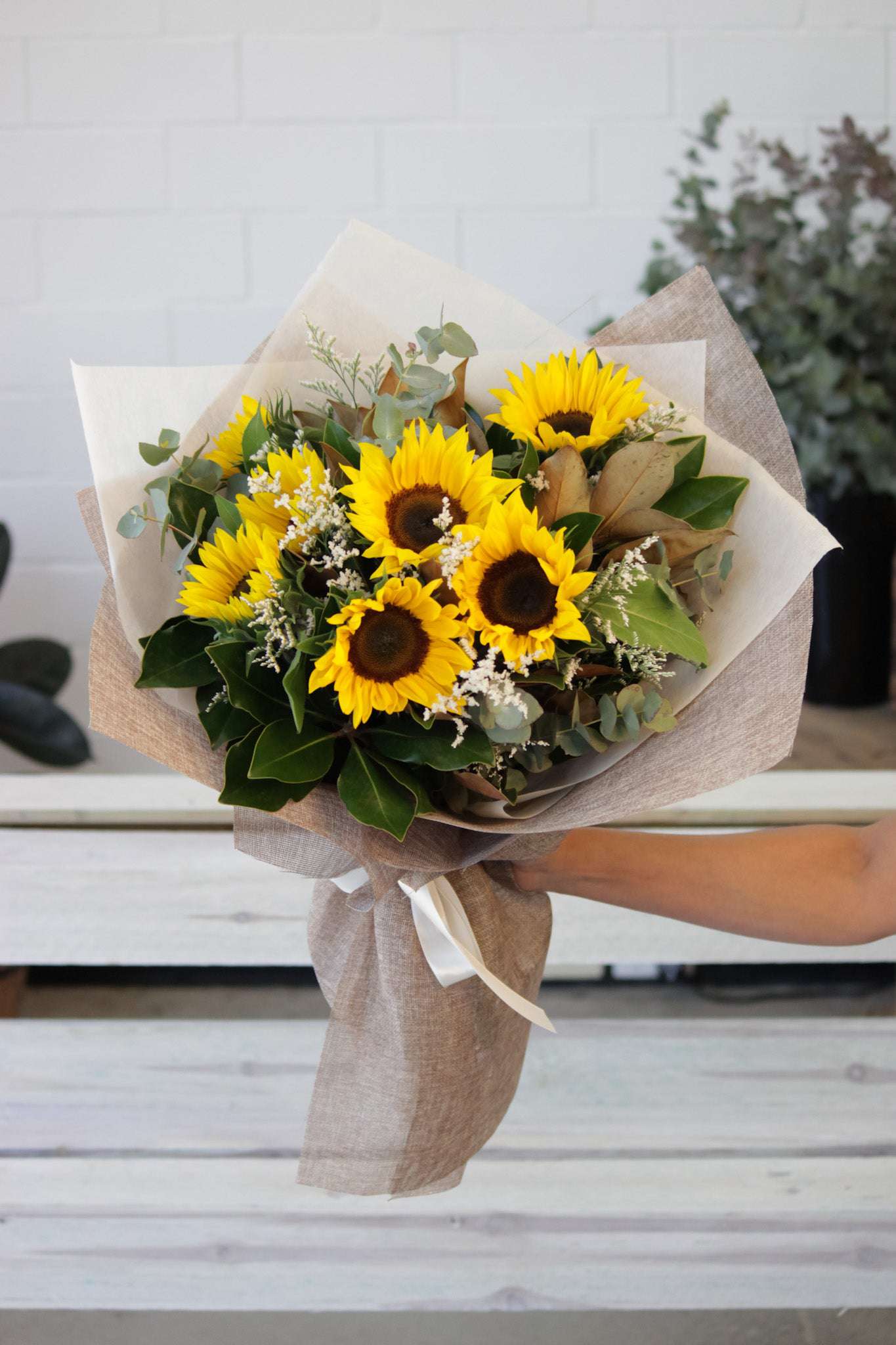 combination-of-sunflowers-and-seasonal-greenery-by-Forest-&-Petals